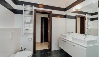 badkamer met bad, inloopdouche, toilet en dubbele wastafel